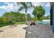 Spacious backyard featuring a pool, hot tub, and fire pit for outdoor enjoyment at 6048 Tremayne Dr, Mount Dora, FL 32757