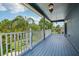 Enjoy the spacious balcony with charming railing overlooking the green lawn at 6048 Tremayne Dr, Mount Dora, FL 32757