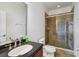 Modern bathroom with brown-tiled walk-in shower and a dark countertop at 6048 Tremayne Dr, Mount Dora, FL 32757