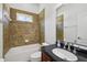 Bathroom with a tub and shower combination, tiled walls, and a vanity with a mirror at 6048 Tremayne Dr, Mount Dora, FL 32757
