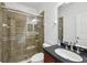 Updated bathroom featuring a glass-enclosed shower, vanity with black countertop and sink at 6048 Tremayne Dr, Mount Dora, FL 32757