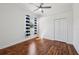 This bedroom features hardwood floors, a closet and a bright window with modern curtains at 6048 Tremayne Dr, Mount Dora, FL 32757