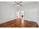 Spacious bedroom featuring hardwood flooring and two entryways under a ceiling fan at 6048 Tremayne Dr, Mount Dora, FL 32757