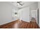 Bedroom with hardwood floors, closet and connecting bathroom under a ceiling fan at 6048 Tremayne Dr, Mount Dora, FL 32757