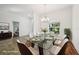 This staged dining room features seating for six and natural light at 6048 Tremayne Dr, Mount Dora, FL 32757