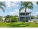 The two story home has a lush lawn with a hot tub and fire pit in the backyard at 6048 Tremayne Dr, Mount Dora, FL 32757