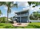 Backyard featuring a fire pit, hot tub, and two-story blue exterior elevation at 6048 Tremayne Dr, Mount Dora, FL 32757