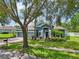 Charming blue single Gathering home with well-maintained landscaping, mature trees and a three car garage at 6048 Tremayne Dr, Mount Dora, FL 32757