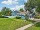 Well-manicured lawn with two car garage and colorful exterior, shows curb appeal and landscaping at 6048 Tremayne Dr, Mount Dora, FL 32757