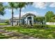 Beautiful home with manicured lawn, a three-car garage, and welcoming front entrance at 6048 Tremayne Dr, Mount Dora, FL 32757