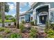 Front exterior features lush landscaping, well manicured lawn, and a three-car garage at 6048 Tremayne Dr, Mount Dora, FL 32757