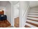 Hallway and staircase featuring wood and white accents, and views into living spaces at 6048 Tremayne Dr, Mount Dora, FL 32757