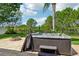 A hot tub with room for the whole Gathering sits next to a stone fire pit at 6048 Tremayne Dr, Mount Dora, FL 32757