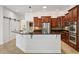 The kitchen features stainless steel appliances, granite countertops, and a breakfast bar at 6048 Tremayne Dr, Mount Dora, FL 32757