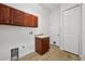 Well-lit laundry room with upper cabinets and a utility sink, offering practicality and storage at 6048 Tremayne Dr, Mount Dora, FL 32757