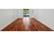 Open living room showcasing hardwood floors and access to the backyard at 6048 Tremayne Dr, Mount Dora, FL 32757