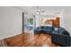 Open-concept living room with hardwood floors flows into kitchen and offers a patio view at 6048 Tremayne Dr, Mount Dora, FL 32757
