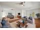 Staged living room with wood floors, ceiling fans and ample seating at 6048 Tremayne Dr, Mount Dora, FL 32757