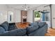 Bright living room features a brick fireplace, hardwood floors, and sliding glass doors to the patio at 6048 Tremayne Dr, Mount Dora, FL 32757
