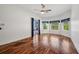 Hardwood flooring, ceiling fan, and bay windows in a main bedroom at 6048 Tremayne Dr, Mount Dora, FL 32757