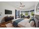 Spacious main bedroom featuring a ceiling fan and large windows at 6048 Tremayne Dr, Mount Dora, FL 32757