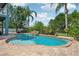 Backyard oasis featuring a beautiful pool with a waterfall feature and a hot tub at 6048 Tremayne Dr, Mount Dora, FL 32757