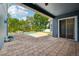 Paver patio overlooking a private pool surrounded by lush landscaping, perfect for outdoor relaxation at 6048 Tremayne Dr, Mount Dora, FL 32757