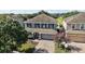 Aerial view of a well-maintained two-story home with lush landscaping and brick driveway at 621 Lost Grove Cir, Winter Garden, FL 34787