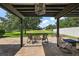 Covered patio with a brick floor, fireplace, and comfortable seating arrangement at 621 Lost Grove Cir, Winter Garden, FL 34787