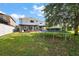 Large backyard featuring covered patios, a trampoline and white vinyl fence at 621 Lost Grove Cir, Winter Garden, FL 34787