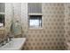 Powder room features a modern sink, decorative mirror, and patterned wallpaper at 621 Lost Grove Cir, Winter Garden, FL 34787