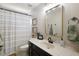 Bathroom with a shower and tub combination with a vanity, sink and decorative mirror at 621 Lost Grove Cir, Winter Garden, FL 34787