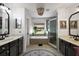 Bathroom boasts dual sinks, soaking tub under window, and glass enclosed shower at 621 Lost Grove Cir, Winter Garden, FL 34787