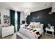 Stylish bedroom features a modern chandelier, statement wall, and natural light at 621 Lost Grove Cir, Winter Garden, FL 34787