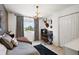 Inviting bedroom with stylish chandelier, plush rug, desk area and bright window at 621 Lost Grove Cir, Winter Garden, FL 34787