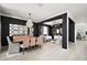 Modern dining and living space with black accent walls, stylish lighting, and light wood floors at 621 Lost Grove Cir, Winter Garden, FL 34787