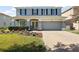 Charming home featuring a two-car garage and a beautifully landscaped front yard at 621 Lost Grove Cir, Winter Garden, FL 34787