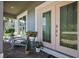 Charming front porch with decorative plants, cozy chairs, and double-door entrance at 621 Lost Grove Cir, Winter Garden, FL 34787