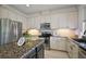 Updated kitchen featuring granite countertops, stainless appliances, and ample cabinet space at 621 Lost Grove Cir, Winter Garden, FL 34787