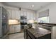 This kitchen offers granite countertops, stainless appliances, and a center island at 621 Lost Grove Cir, Winter Garden, FL 34787