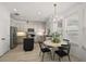 Eat-in kitchen area offers modern lighting, an island, and stainless steel appliances at 621 Lost Grove Cir, Winter Garden, FL 34787