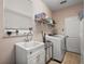 Practical laundry room features ample storage and modern appliances with natural lighting at 621 Lost Grove Cir, Winter Garden, FL 34787