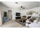 Comfortable living room with a ceiling fan, modern decor, and plenty of natural light at 621 Lost Grove Cir, Winter Garden, FL 34787