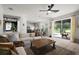 Bright living room boasts an open floor plan, wood floors, and sliding doors to the patio at 621 Lost Grove Cir, Winter Garden, FL 34787