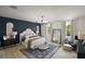 The main bedroom features a large bed and a matching dark blue accent wall at 621 Lost Grove Cir, Winter Garden, FL 34787