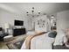 Bright main bedroom with a modern chandelier, black dresser and mounted TV at 621 Lost Grove Cir, Winter Garden, FL 34787