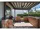 Covered patio area with a built-in brick grill, perfect for outdoor cooking and entertaining at 621 Lost Grove Cir, Winter Garden, FL 34787