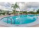 Inviting community pool with clear blue water, a handrail, and well-maintained landscaping, perfect for relaxation at 621 Lost Grove Cir, Winter Garden, FL 34787