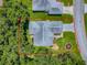 An aerial view of a cozy home with well-maintained landscaping and a driveway surrounded by red at 627 Timbercrest Dr, Leesburg, FL 34748