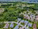 Neighborhood aerial view of well-maintained homes in a community with ponds and lush surroundings at 627 Timbercrest Dr, Leesburg, FL 34748